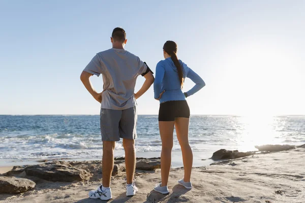 Jong (echt) paar op het strand training samen — Stockfoto