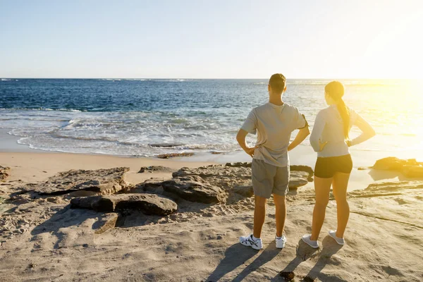 Jong (echt) paar op het strand training samen — Stockfoto