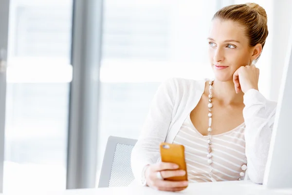 Attractive office worker sitting at desk — Stock Photo, Image