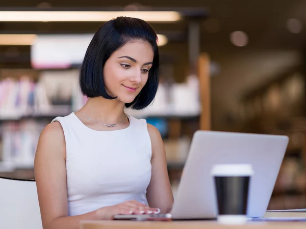 Happy female student at the library — Stock Photo, Image