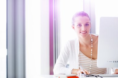 Çekici ofis çalışanı masada oturuyor.