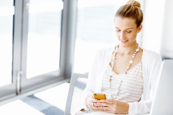 Attractive office worker sitting at desk — Stock Photo, Image