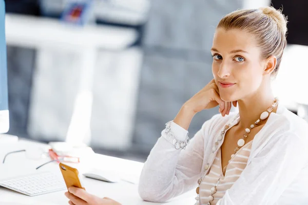 Attractive office worker sitting at desk — Stock Photo, Image