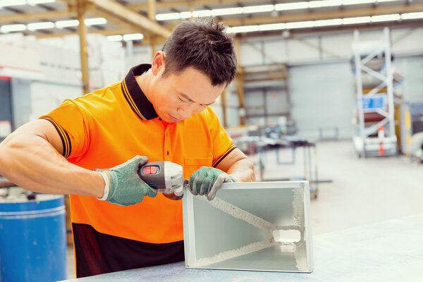 Asian worker in production plant on the factory floor