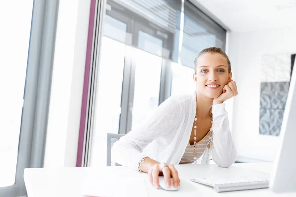 Attractive office worker sitting at desk — Stock Photo, Image