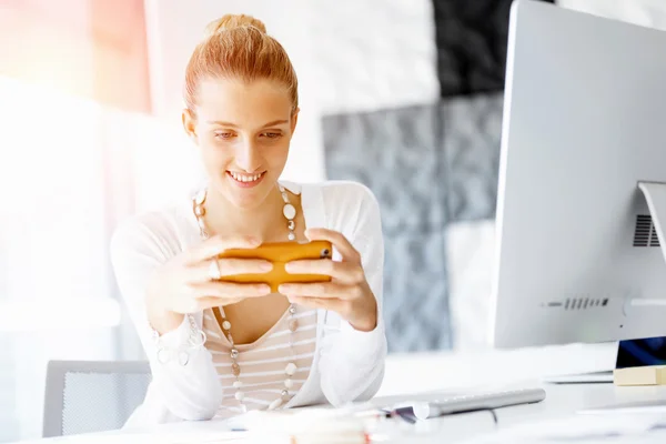 Attractive office worker sitting at desk — Stock Photo, Image