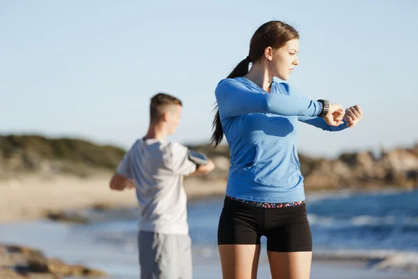 Jong (echt) paar op het strand training samen — Stockfoto