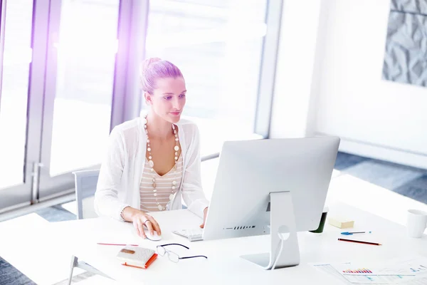 Attractive office worker sitting at desk — Stock Photo, Image