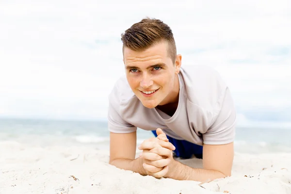 Man training on beach outside Stock Photo