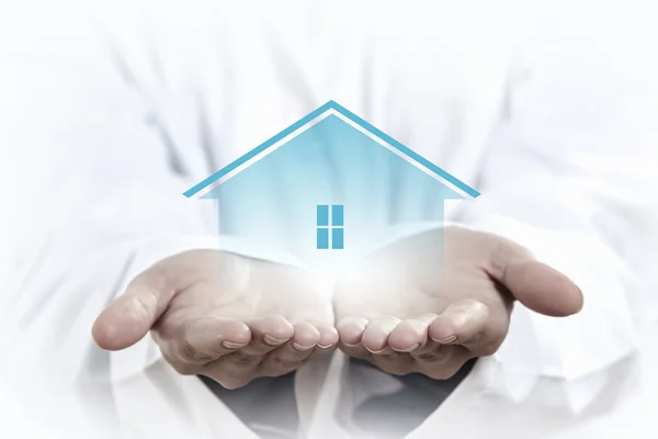 House sign in female hand — Stock Photo, Image