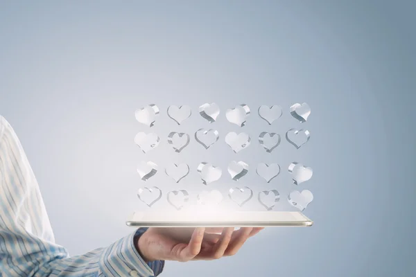 Tablet in hand with symbols — Stock Photo, Image