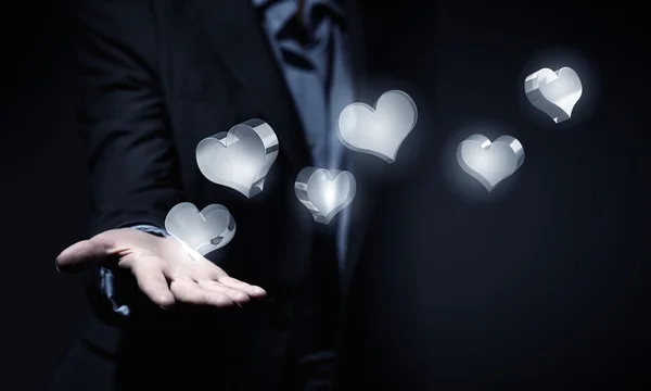 Серце скляні значки в долоні — стокове фото