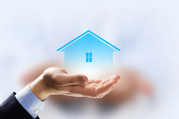 House sign in male hand — Stock Photo, Image