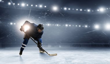 Ice hockey player at rink clipart