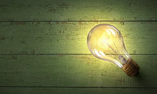 Light bulb op houten oppervlak — Stockfoto
