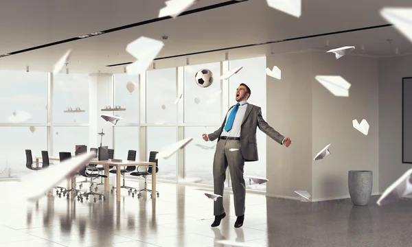 Playing football in office — Stock Photo, Image