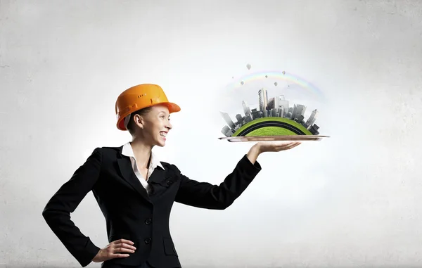 Woman presenting construction model — Stock Photo, Image