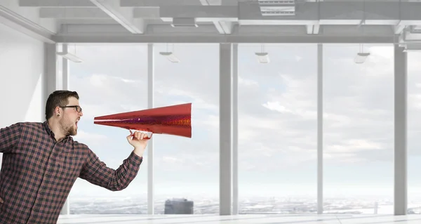 Man shouting in pape cone — Stock Photo, Image