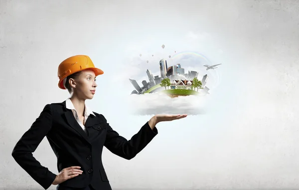 Woman presenting construction model — Stock Photo, Image