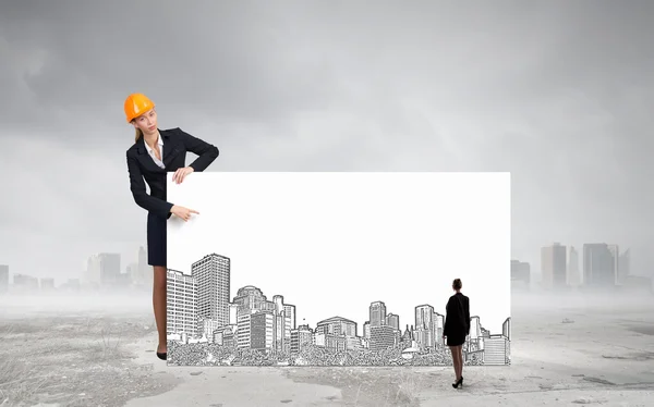 Builder woman with banner — Stock Photo, Image