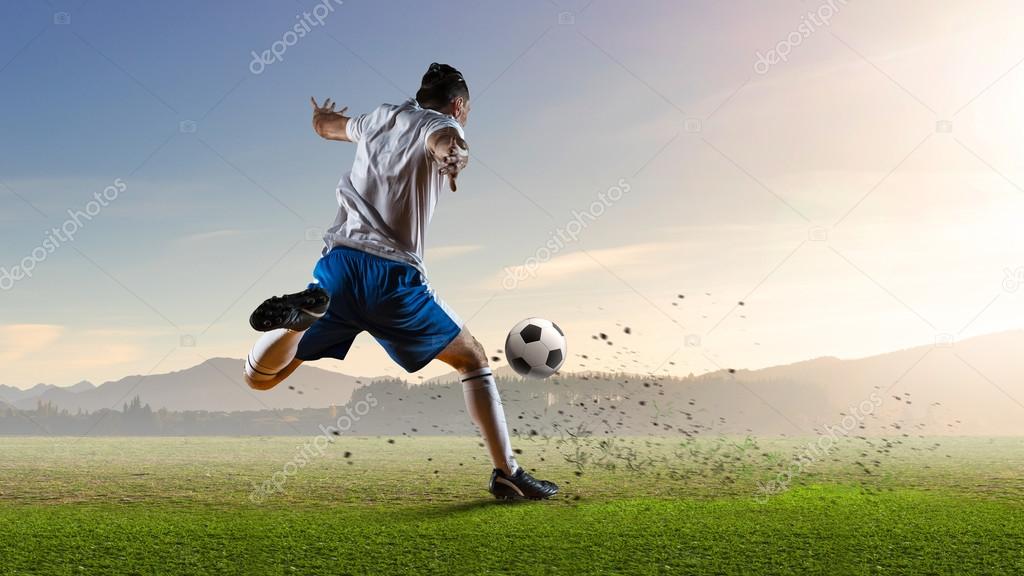 Soccer player hitting ball Stock Photo by ©SergeyNivens 112361504