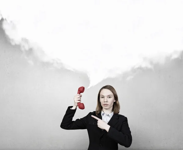 Woman holding red phone handset — Stock Photo, Image