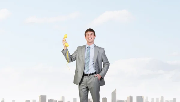 Empresário com receptor amarelo — Fotografia de Stock