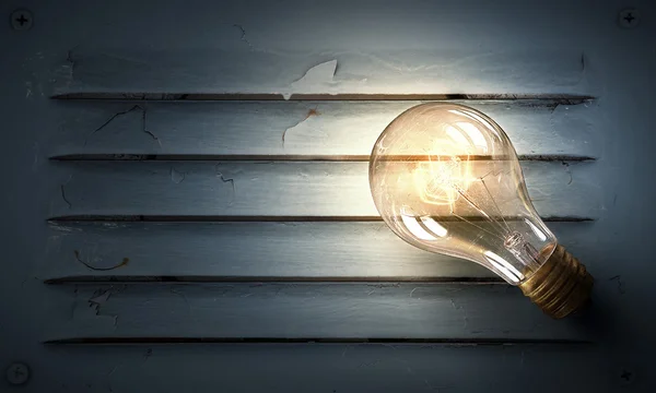 Light bulb on metal surface — Stock Photo, Image
