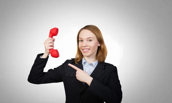 Frau mit rotem Telefonhörer — Stockfoto