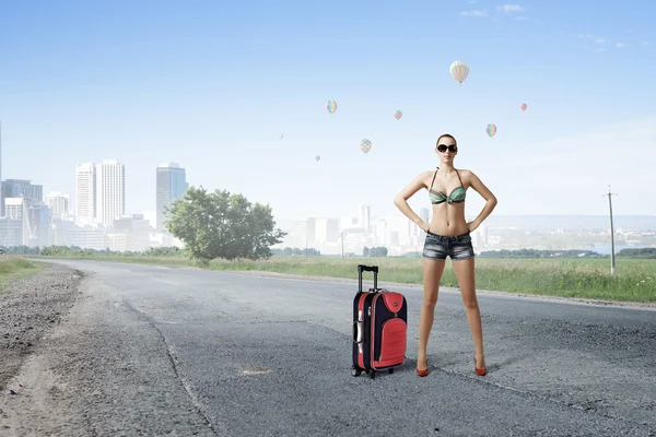 Hitch hiker woman on road Stock Photo