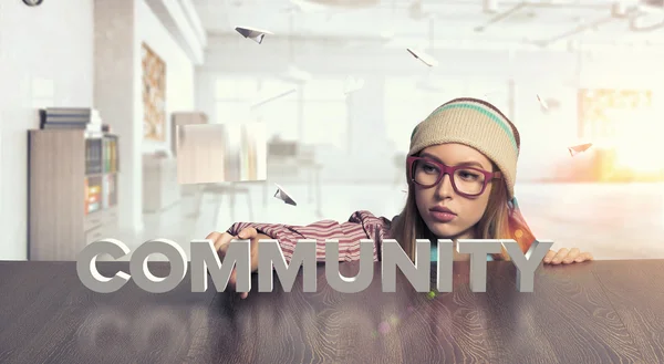 Hipster girl looking from under table — Stock Photo, Image