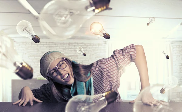 Hipster girl looking from under table — Stock Photo, Image