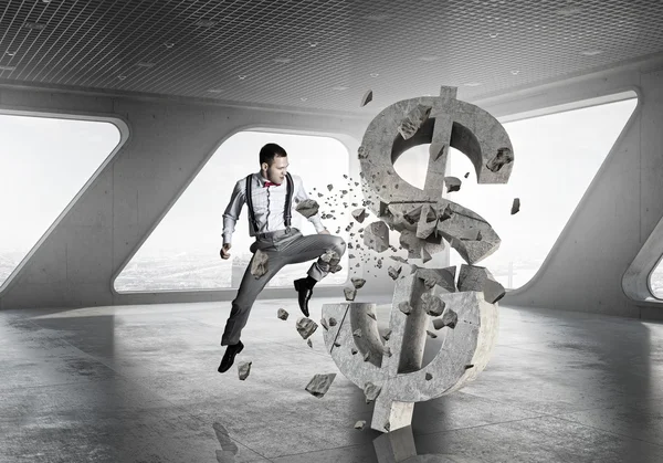 Man attacking dollar symbol — Stock Photo, Image