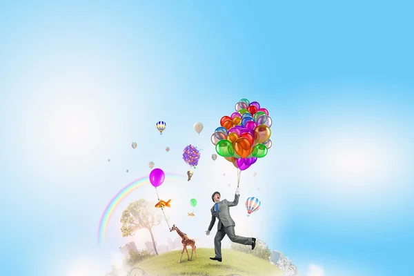 Komik muž s barevné balónky — Stock fotografie