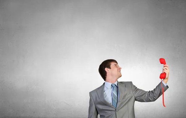 Businessman with red receiver — Stock Photo, Image