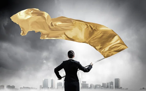 Vrouw wuivende gele vlag. Mixed media — Stockfoto