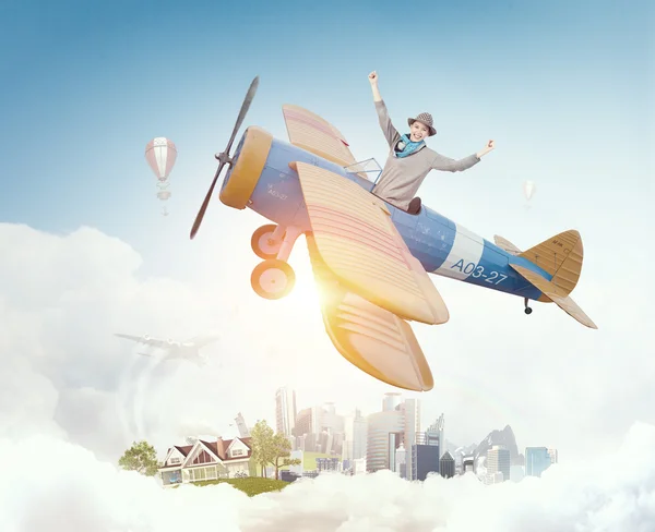 Girl flying old plane . Mixed media — Stock Photo, Image