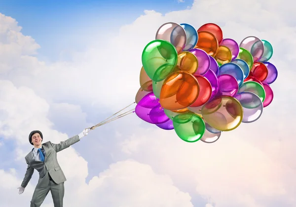 Homem cómico com balões coloridos. Meios mistos — Fotografia de Stock