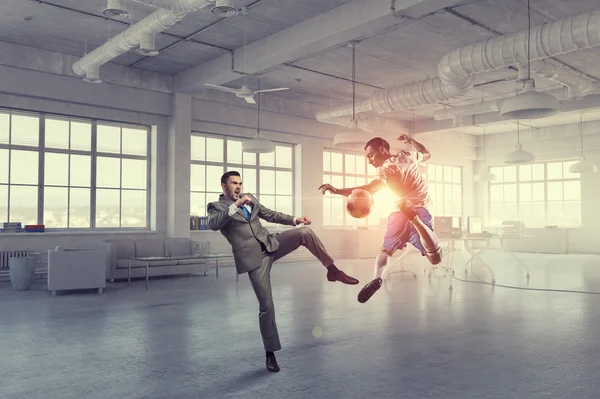 Playing football in office . Mixed media — Stock Photo, Image