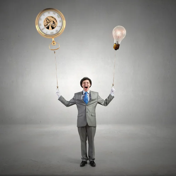 Comedian man with color balloons . Mixed media — Stock Photo, Image