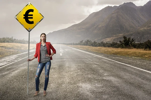 Pretty girl with roadsign . Mixed media — Stock Photo, Image