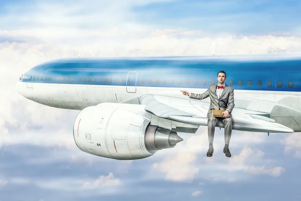 On wing of flying airplane . Mixed media — Stock Photo, Image
