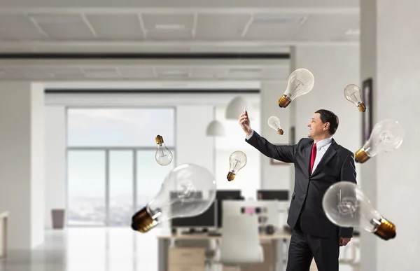 Businessman with mobile phone in hand . Mixed media — Stock Photo, Image