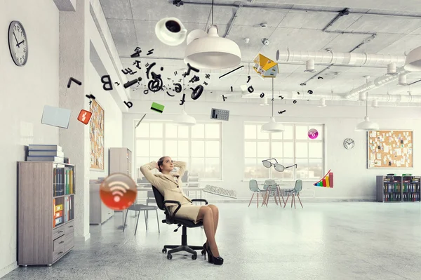 Businesswoman having rest in office . Mixed media — Stock Photo, Image