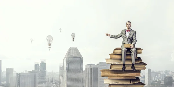 Businessman with old book . Mixed media — Stock Photo, Image