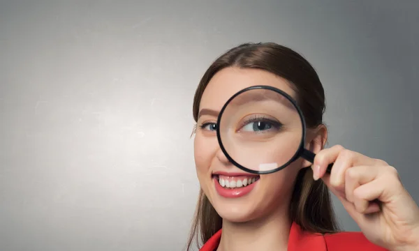 Girl using magnifier for search . Mixed media — Stock Photo, Image