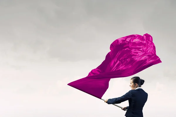 Woman waving red flag . Mixed media — Stock Photo, Image