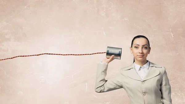 Woman using deaf phone . Mixed media — Stock Photo, Image