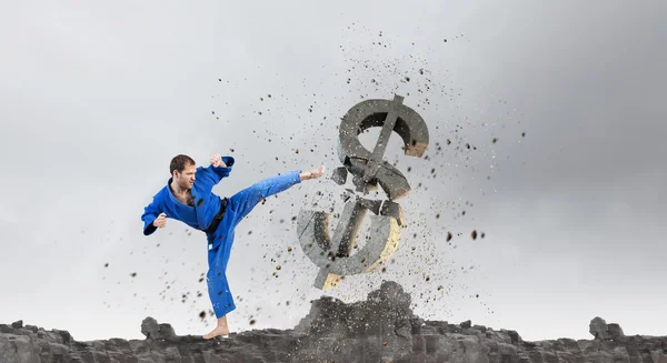 Hombre de karate atacando dólar. Medios mixtos —  Fotos de Stock