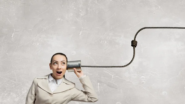 Woman using deaf phone . Mixed media — Stock Photo, Image